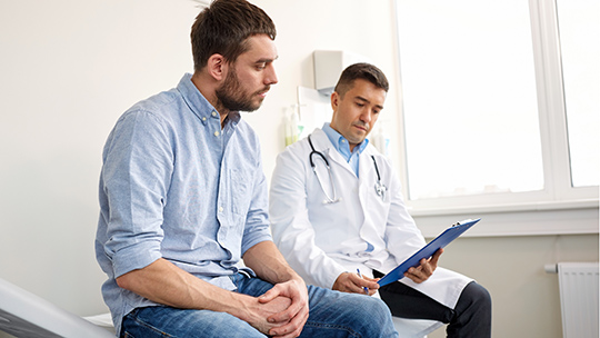 Young male patient meeting with a doctor in a doctor's office.