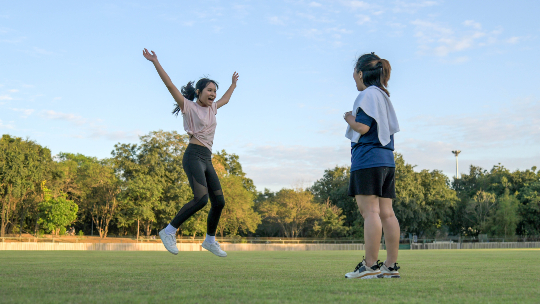 girl-jumping-with-mom